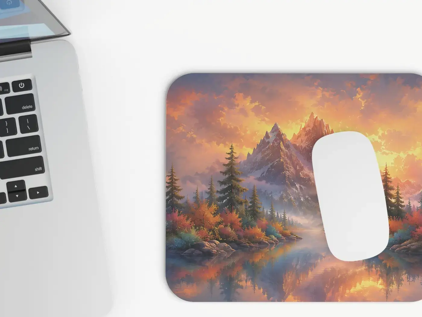 Mountain landscape mouse pad beside a laptop